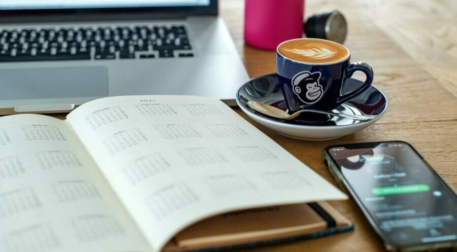 a coffee cup and a pen on a desk